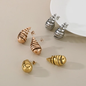 Detailed view of spiral hollow stainless steel earrings in silver, rose gold and gold