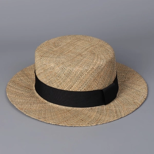 Close-up of handmade boater hat texture with natural weaving and black ribbon