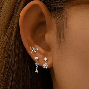 Detailed view of s925 silver moonstone and zircon studs worn on a model's ear