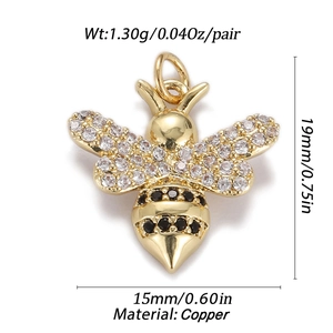 Detailed view of gold honey bee pendant with white and black cubic zirconia stones