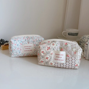 Close-up of French floral quilted cotton toast bags with zippers and vintage pattern