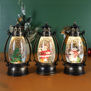 Three vintage bronze Christmas snow globe lanterns with Santa, Snowman, and Tree figurines