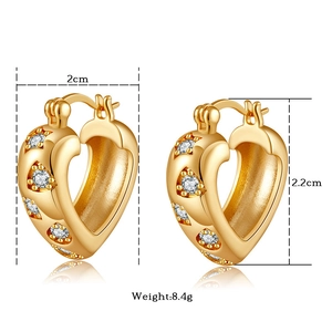 Detail view of 2cm gold heart earrings with zircon inlay showing size and weight info