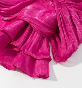 Macro shot of shimmering rose red metallic pleated fabric with fine texture detail