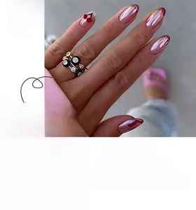 Detail of metallic pink French press-on nails with red cherry tips and 3D droplet accents