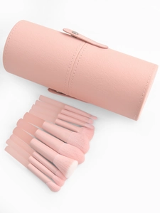 Detailed set of 10 peach pink makeup brushes with matching cylinder travel case