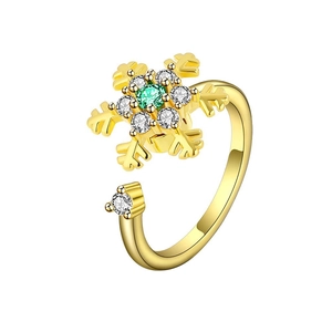 Detail view of rotatable gold snowflake ring with green zircon and pavé stones
