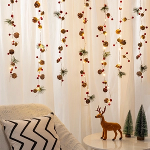 Festive Christmas LED string lights with pine cones, red berries and warm white bulbs