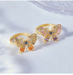 Detailed macro shot of gold butterfly rings with colorful cubic zirconia stones