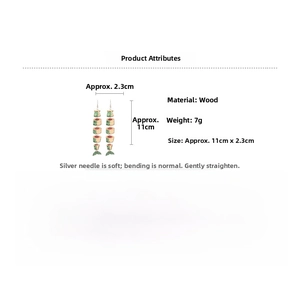 Detail view of ethnic wood print fish earrings with tassel showing 11cm length size