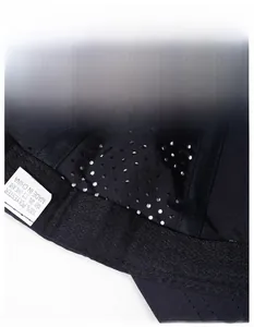 Detail of breathable mesh fabric and moisture-wicking sweatband inside black baseball cap
