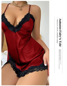 Detail of red satin nightgown with delicate black eyelash lace trim and silk texture