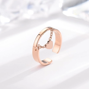 Minimalist rose gold open chain ring with heart pendant on a clean white background