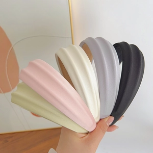 Close-up of colorful wave texture headbands in green, pink, beige, gray and black