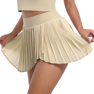 Detail view of the beige pleated tennis skirt featuring a high waist and athletic fabric