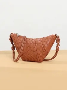 Brown woven leather croissant shoulder bag with knotted strap and crescent shape