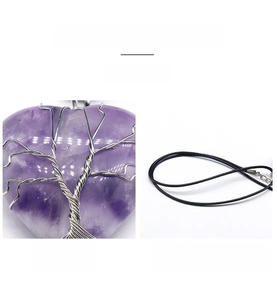 Macro detail of wire-wrapped amethyst heart pendant with life tree pattern and black cord