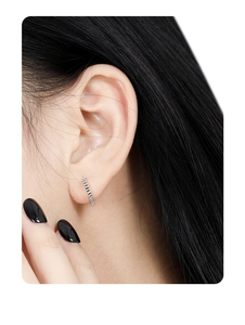 Detailed macro view of S925 sterling silver hoop earring with vertical textured folds