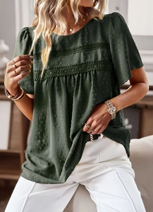 Close-up detail of dark green textured fabric with lace trim on a women short sleeve top