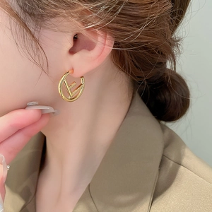 Elegant gold metal letter E circular hoop earrings for women with minimalist geometric style