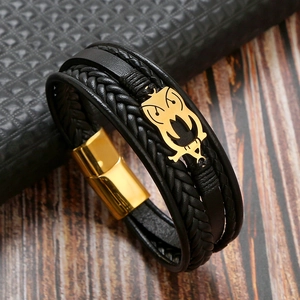 Detail of black multi-layer leather bracelet with gold owl motif and magnetic clasp
