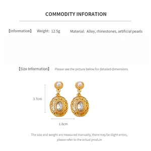 Detail view of vintage gold pendant earrings with pearls and rhinestones size 3.7x1.8cm