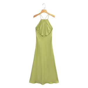 Close-up of grass green satin halter dress with smooth silk texture and open back design