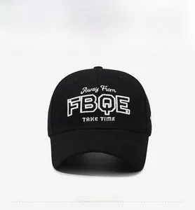 Close-up of white 3D embroidery text on black cotton twill baseball cap fabric