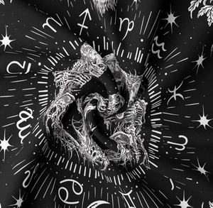 Close-up of bohemian zodiac tapestry showing white celestial patterns and starry fabric texture