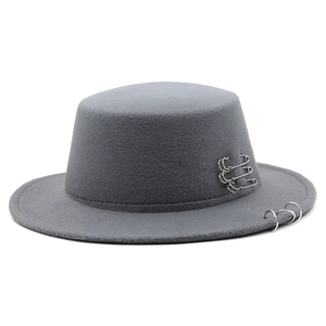 Detail of dark grey wool felt flat top hat featuring silver metal pins and ring accents