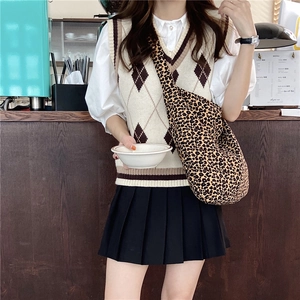 Leopard print canvas crossbody bag shown on a model with a vintage aesthetic look