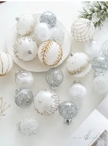 Close-up of assorted champagne and silver Christmas balls with glitter and sequin details