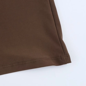 Detail view of coffee brown knit fabric with fine stitching and soft texture