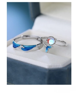 Macro shot of S925 sterling silver whale tail ring with blue enamel and moonstone detail