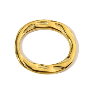 Macro detail of a twisted geometric gold stainless steel ring with textured finish