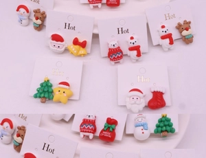 Detailed view of kids clip-on earrings set with Santa, reindeer, and snowman charms