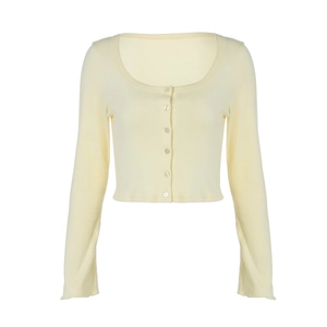 Detailed view of the ribbed texture and buttons on the yellow slim-fit cardigan