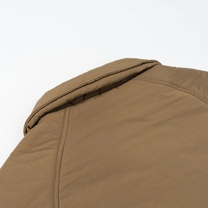 Detailed close-up of the back collar stitching on a brown casual quilted cotton coat