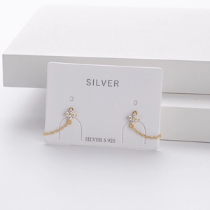 Detail showing gold S925 silver flower stud earrings with tassels and white zircon micro-inlays