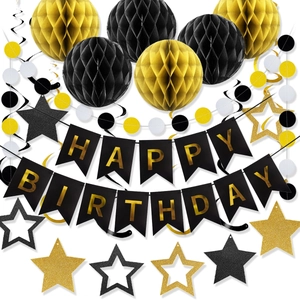 Detailed view of black and gold birthday party set with honeycomb balls and banners