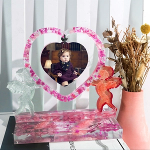 Detailed heart-shaped resin frame with pink flowers and Cupid angel statues