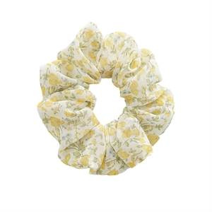 Floral print yellow scrunchie with green leaves on white background for women