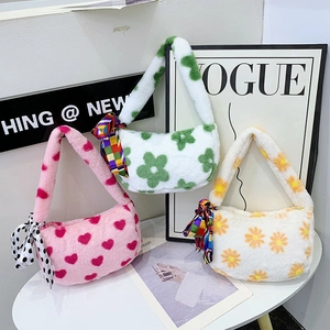 Three plush faux fur shoulder bags featuring heart and floral patterns with silk scarves