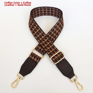 Detail of adjustable coffee houndstooth strap with leather ends and gold metal hooks