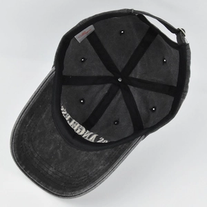 Detailed interior of dark gray washed denim baseball cap with adjustable buckle and stitching