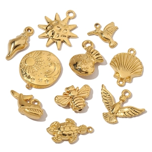 Golden titanium steel charms collection featuring sun, bird, and shell pendants
