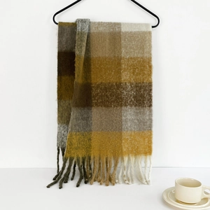Close-up of soft plaid mohair scarf in brown and yellow tones with fringe detail