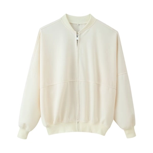 Detailed view of cream bomber jacket neckline with size M tag on smooth fabric