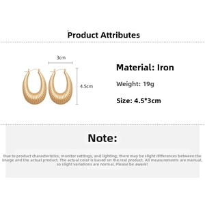 Detailed view of gold oval U-shaped earrings with vertical textured stripes and dimensions