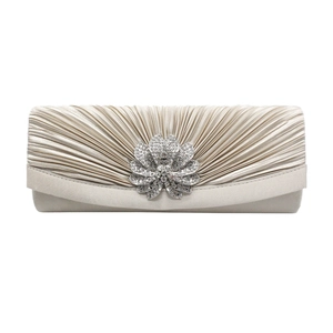 Detail of champagne satin evening clutch with radial pleats and oversized rhinestone flower